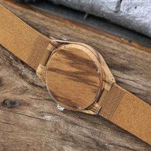 Men quartz wristwatch with a unique wooden design, showcasing annual rings and block points on the face, paired with black hands. Features a brown genuine leather strap and is ideal for sports and casual wear.