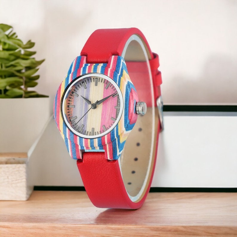 Elegant ladies quartz wristwatch featuring colorful stripes on a bamboo wood face, secured with a pin buckle on a genuine leather watchband. Ideal for casual wear.