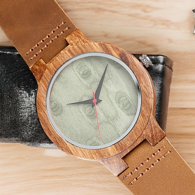 Stylish minimalist wristwatch featuring a wood case with a choice of black, brown, or green dial, complemented by a genuine leather strap. Ideal for both men and women, perfect as a gift.