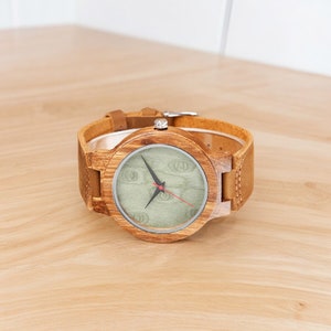 Stylish minimalist wristwatch featuring a wood case with a choice of black, brown, or green dial, complemented by a genuine leather strap. Ideal for both men and women, perfect as a gift.