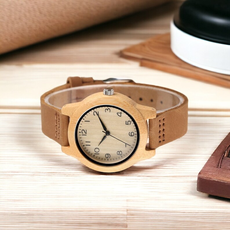 Elegant bamboo wooden ladies bracelet watch with a soft leather band, showcasing a simple yet casual design. Ideal as a gift for women.