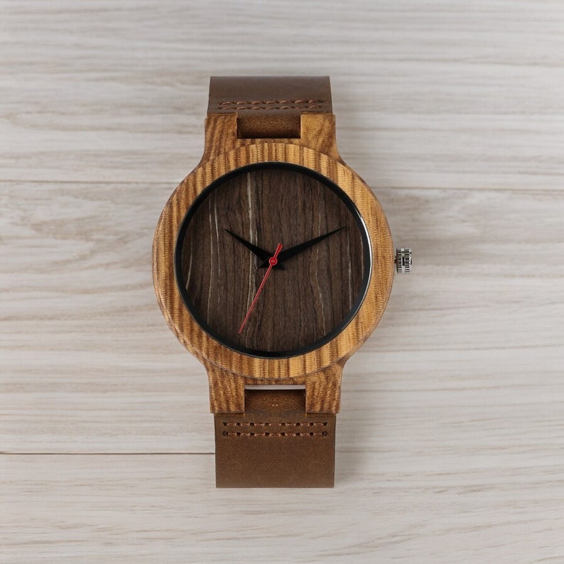 Stylish minimalist wristwatch featuring a wood case with a choice of black, brown, or green dial, complemented by a genuine leather strap. Ideal for both men and women, perfect as a gift.