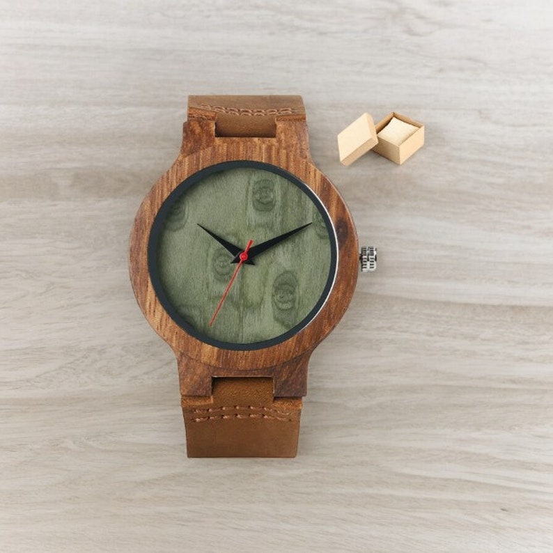 Stylish minimalist wristwatch featuring a wood case with a choice of black, brown, or green dial, complemented by a genuine leather strap. Ideal for both men and women, perfect as a gift.
