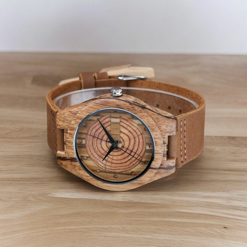 Men quartz wristwatch with a unique wooden design, showcasing annual rings and block points on the face, paired with black hands. Features a brown genuine leather strap and is ideal for sports and casual wear.