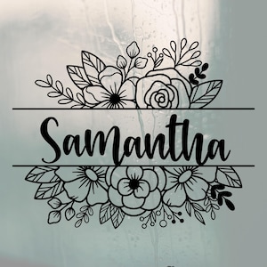 May include: Black floral design with the name "Samantha" in a cursive font. The name is centered between two horizontal lines, with floral arrangements above and below. The design includes roses, leaves, and other floral elements.
