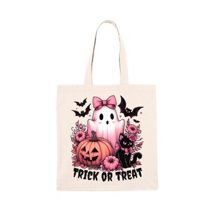 A whimsical png illustration of a cute pink ghost with a pink bow, a black cat with a pink bow, a pumpkin with a jack-o-lantern face, and pink flowers. Perfect for personalizing Halloween t-shirts, hoodies, sweatshirts, tote bags, tumblers, and mugs.