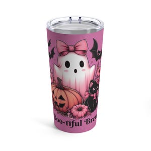 A pink stainless steel tumbler with a ghost, pumpkin, black cat, and flowers. The text 'Boo-tiful Brew' is on the bottom of the tumbler.