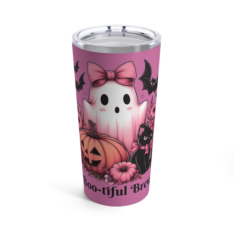 A pink stainless steel tumbler with a ghost, pumpkin, black cat, and flowers. The text 'Boo-tiful Brew' is on the bottom of the tumbler.