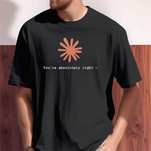 May include: Black t-shirt with a coral-colored flower graphic and the text "You're absolutely right -". The shirt is made of a soft material and has short sleeves.