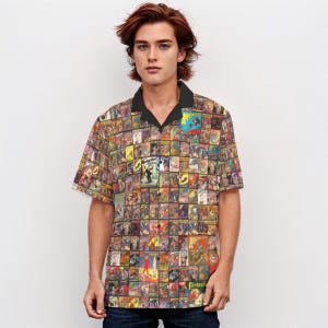 May include: A short-sleeved button-up shirt with a colorful pattern of vintage comic book covers. The shirt has a black collar and a button-up front.