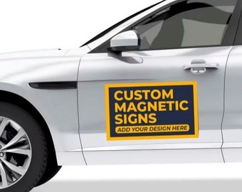 May include: A white car with a custom magnetic sign that says "CUSTOM MAGNETIC SIGNS ADD YOUR DESIGN HERE" in yellow letters on a blue background.