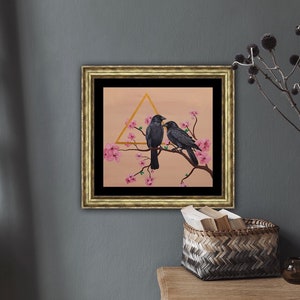 Golden wood frame with a black matte. Painting of two black crows on a cherry blossom branch and a unique golden metallic triangle.