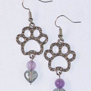 Puppy or kitty paw print earrings, silver plated with Rhinestones. Silver nickel free hooks and iridescent heart beads dangling from the bottom.