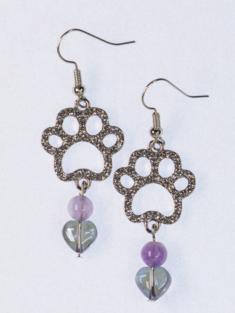 Puppy or kitty paw print earrings, silver plated with Rhinestones. Silver nickel free hooks and iridescent heart beads dangling from the bottom.
