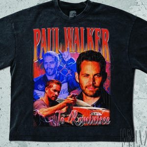 May include: Black t-shirt featuring a graphic of Paul Walker with the text "Paul Walker" in red. The design includes multiple images of the actor and the text "To Reminisce" in orange. The shirt has a vintage, distressed look.