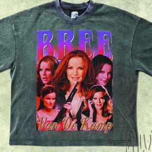May include: A grey t-shirt with a graphic featuring the word "BREE" in purple and pink, and images of a woman. The text "Van De Kamp" is below. The shirt has a vintage, distressed appearance.