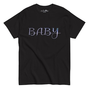 May include: Black t-shirt featuring the word "BABY" in a cursive, light blue and purple font. The text is centered on the chest. The shirt has a crew neck and is made of a soft material. The design is simple and elegant.