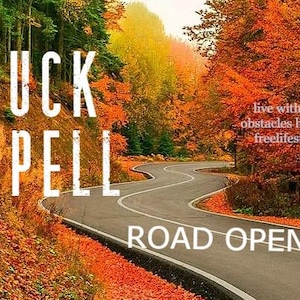 May include: A winding road through a forest with vibrant autumn foliage. The image features the text "LUCK SPELL ROAD OPEN" and "live without obstacles hassle freelifestyle". The scene is filled with warm colors.