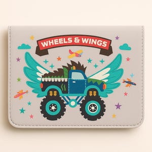 May include: A light gray wallet with a cartoon illustration of a blue monster truck with teal wings and large black wheels. The text "WHEELS & WINGS" is on a red banner above the truck. Colorful stars, clouds, and airplanes decorate the background.