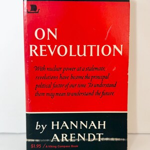 May include: A paperback book titled On Revolution by Hannah Arendt. The cover features a bright red background with white text, a black horizontal band at the bottom, and a small black Viking ship logo in the top left corner. The text reads: With nuclear power at a stalemate, revolutions have become the principal political factor of our time. To understand them may mean to understand the future.