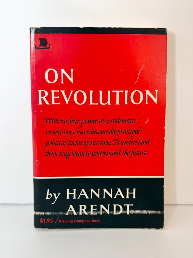 May include: A paperback book titled On Revolution by Hannah Arendt. The cover features a bright red background with white text, a black horizontal band at the bottom, and a small black Viking ship logo in the top left corner. The text reads: With nuclear power at a stalemate, revolutions have become the principal political factor of our time. To understand them may mean to understand the future.