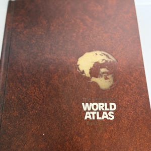 Vintage 1979 Rand McNally World Atlas book with color illustrations