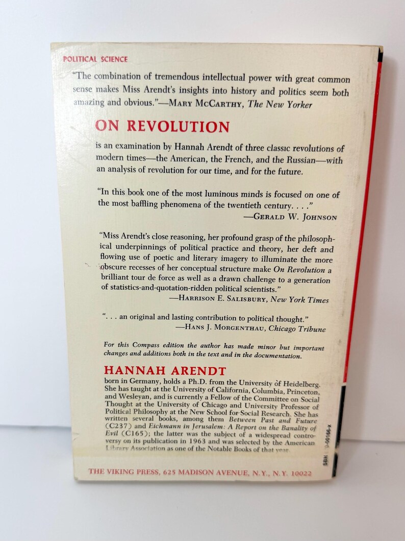 May include: The back cover of the book On Revolution by Hannah Arendt, published by The Viking Press. The cream-colored cover features red and black text, including reviews from The New Yorker, The New York Times, and Chicago Tribune.