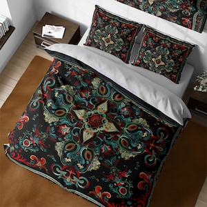 May include: A black duvet cover with a large, intricate floral pattern in shades of red, green, and gold. The pattern is reminiscent of traditional folk art. The duvet cover is shown on a bed with two matching pillowcases.