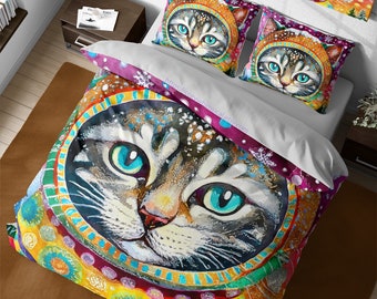 May include: A colorful duvet cover with a large illustration of a cat wearing a space helmet. The cat has blue eyes and a white nose. The background is a mix of bright colors and patterns.
