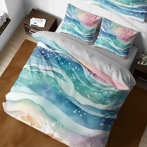 May include: A watercolor duvet cover with a design of blue, green, and white waves. The waves are layered and have a soft, dreamy look. The duvet cover is made of soft, breathable fabric and is perfect for adding a touch of whimsy to your bedroom.