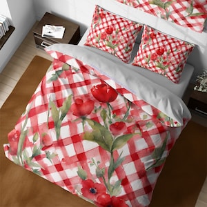 May include: Red and white gingham bedding with a floral pattern of red poppies and green leaves. The bedding is made of soft, comfortable fabric and is perfect for adding a touch of whimsy to any bedroom.