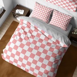 May include: Pink and white checkered bedding set with a duvet cover and two pillowcases. The bedding is made of soft, comfortable fabric and features a classic checkered pattern.