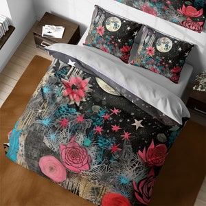 May include: A black and white duvet cover with a floral and moon design. The duvet cover features pink, blue, and white flowers, a full moon, and stars. The duvet cover is made of a soft, comfortable fabric and is perfect for adding a touch of whimsy to any bedroom.