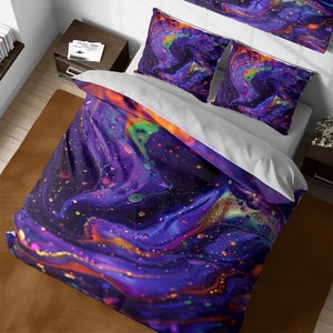 May include: A purple, orange, and gold abstract bedding set with a swirling, galaxy-like pattern. The set includes a duvet cover and two pillowcases.