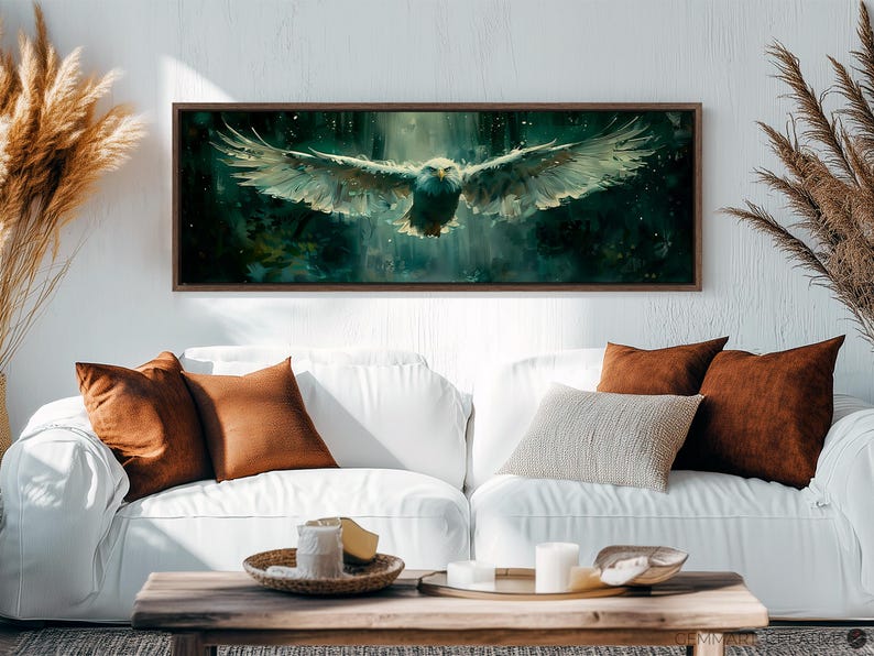 May include: A framed canvas print of a white eagle in flight against a dark green and blue background. The eagle is flying towards the viewer with its wings spread wide. The background is blurred and has a watercolor effect.