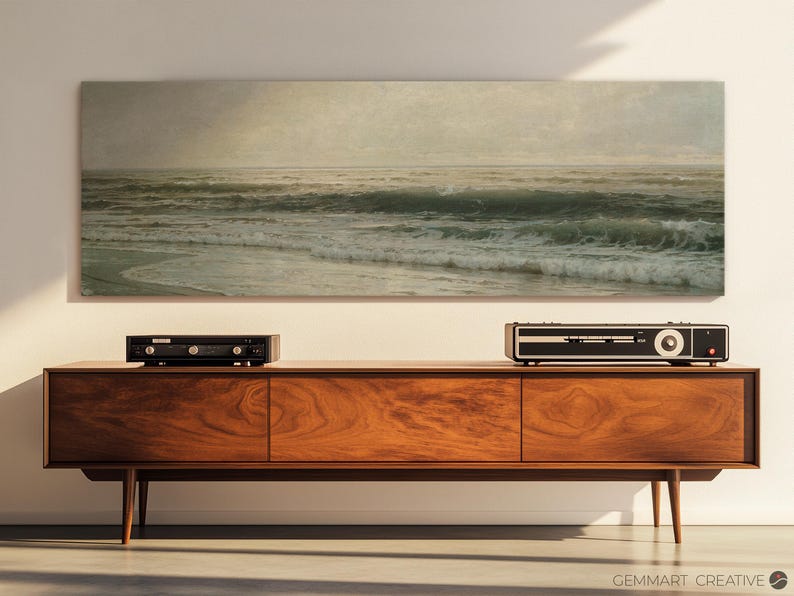 May include: A vintage-style wooden entertainment center with a black stereo receiver and a framed seascape painting above it.