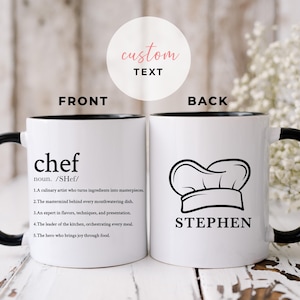 May include: White ceramic mug with a black rim and handle. The front of the mug has the word "chef" defined as a culinary artist who turns ingredients into masterpieces. The back of the mug has a chef's hat and the name "STEPHEN".