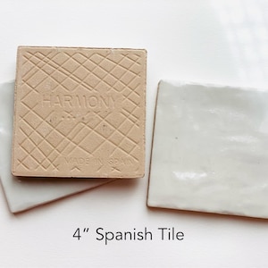 May include: Two square white tiles with a glossy finish and one tile showing the reverse side with a grid pattern, the text HARMONY, and MADE IN SPAIN. The tiles are 4 inches in size as indicated by the text 4" Spanish Tile below them.