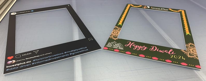 May include: Two photo booth frames. The first frame is black with white text that reads "InvestPlus.au #data-driven #informedinvestments #forsmartinvestors #multiplywithus #growwithus". The second frame is green with yellow, pink, and white accents. The text reads "Happy Diwali 2021".