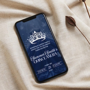May include: A smartphone displays a navy blue quincea&ntilde;era invitation. The invitation features a white crown design and elegant script. Text includes the names Jennifer & Martin Varela, the name Summer Smith, and the date February 25, 2020.