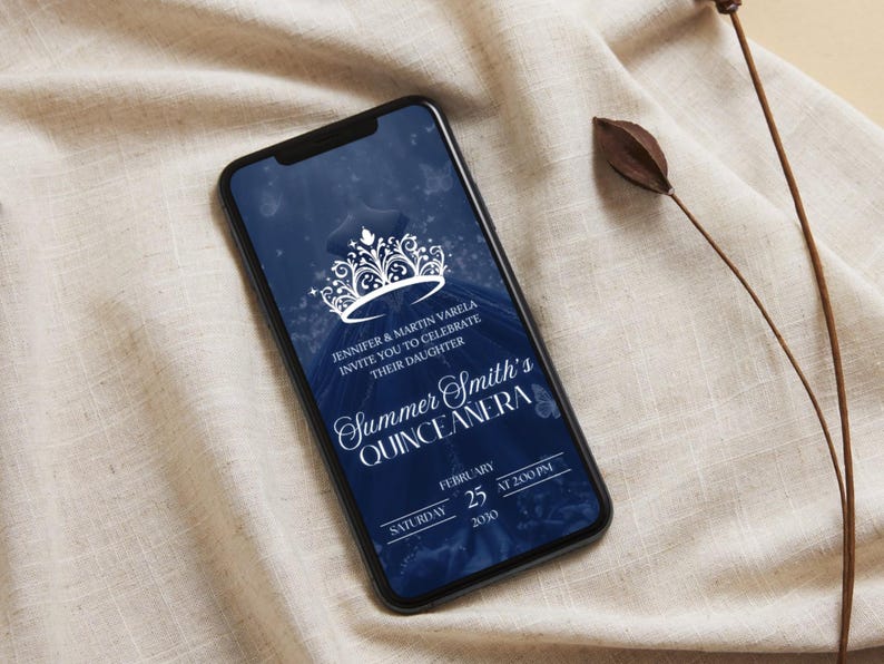 May include: A smartphone displays a navy blue quincea&ntilde;era invitation. The invitation features a white crown design and elegant script. Text includes the names Jennifer & Martin Varela, the name Summer Smith, and the date February 25, 2020.