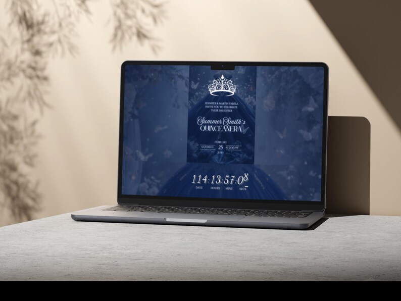 May include: A laptop displays a Quincea&ntilde;era invitation. The screen shows a dark blue background with a tiara graphic and the text "Summer Smith's Quincea&ntilde;era." A countdown timer is visible at the bottom. The laptop is on a gray surface.