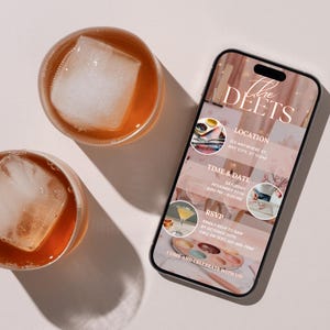 May include: Two glasses of amber-colored liquid with large ice cubes sit next to a smartphone. The phone displays an invitation with the text "The Deets", location, time, date, and RSVP information. The invitation has a pink and white color scheme.