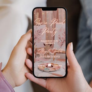 May include: A smartphone displays a digital invitation for a "Sip n Paint Party" with floral accents. The invitation includes details for Angel Smith's 25th birthday on November 30th at 4:00 PM. The phone is held in two hands.