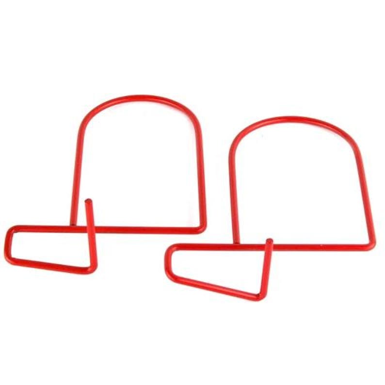 May include: Two red metal bookends. Each bookend has a curved top and a rectangular base, connected by a vertical support. The design is simple and functional, suitable for organizing books on a shelf or desk.