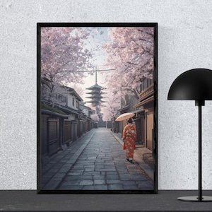 以下が含まれることがあります： 日本の街並みを描いた額入りのアートプリント。着物を着た人が傘を持ち、石畳の道を歩いています。桜並木が通りに並び、遠くには塔があります。プリントは黒いフレームに入っています。