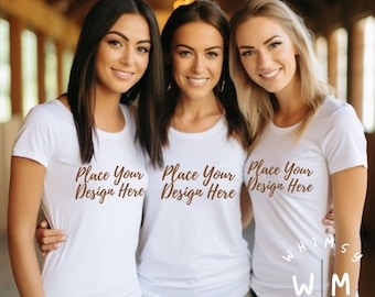 May include: Three women wearing white t-shirts with the text "Place Your Design Here" in brown script. The shirts are short-sleeved and have a crew neck. The image also includes the text "WHIMSY MOCKERY" and "WM MOCKERS".