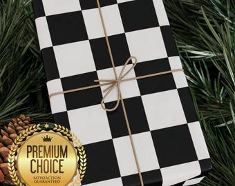 May include: A present wrapped in black and white chequered paper, tied with twine. The gift is surrounded by pine needles and pine cones. A gold seal with the words "Premium Choice" is visible.