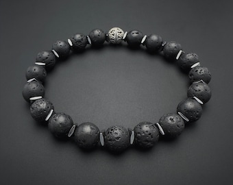 May include: Black lava rock beaded bracelet with a silver bead accent.