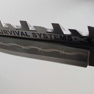 May include: A black and silver knife with a serrated edge and a barbed wire design. The knife has the text "SURVIVAL SYSTEMS - 3" on the blade.